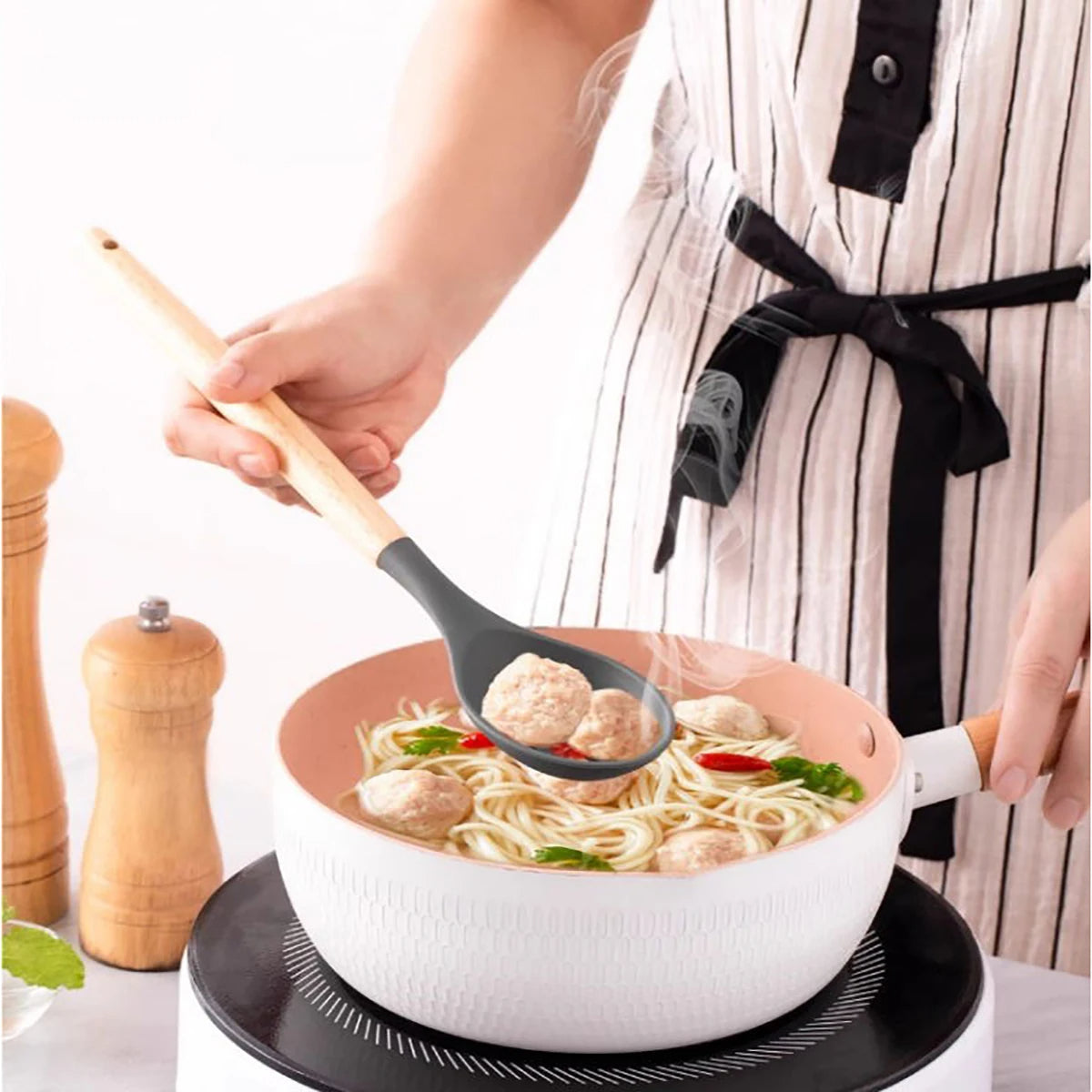 Person ladling soup with a ladle into a bowl, wearing an apron. silicone wooden handle kitchen utensil set Pakistan.