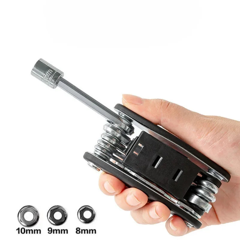 Multifunctional tool with interchangeable heads held by a hand on a white background. 8 9 10 mm socket bike tool, 14G spoke wrench multitool, hex 2 2.5 3 4 5 6 mm tool, budget bike multitool.