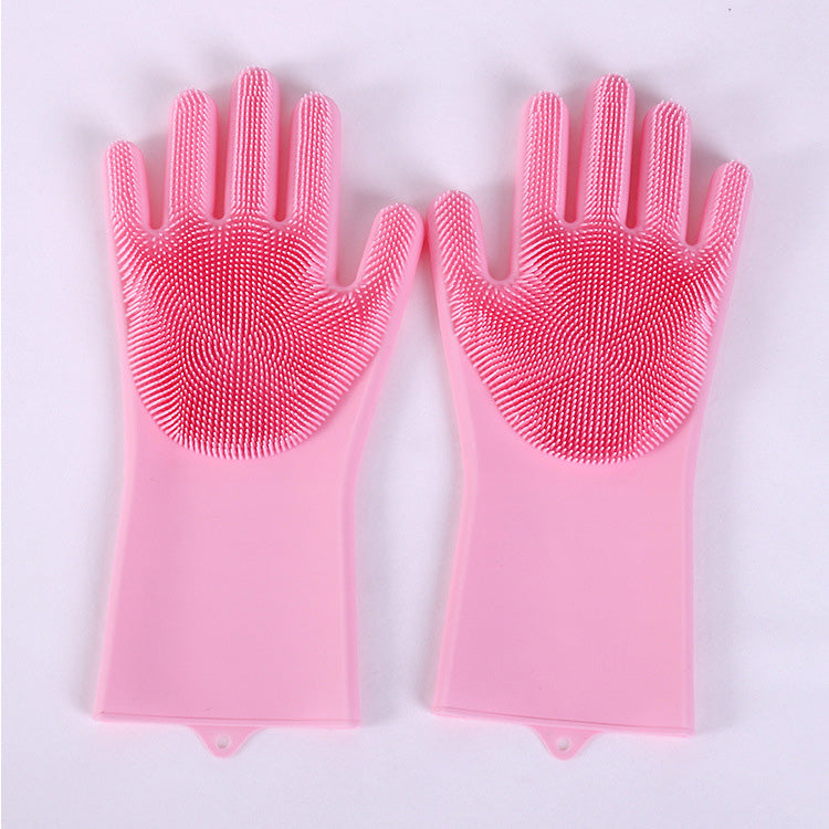 Pair of pink silicone gloves on a white background, magic silicone scrubber gloves, heat resistant dishwashing gloves