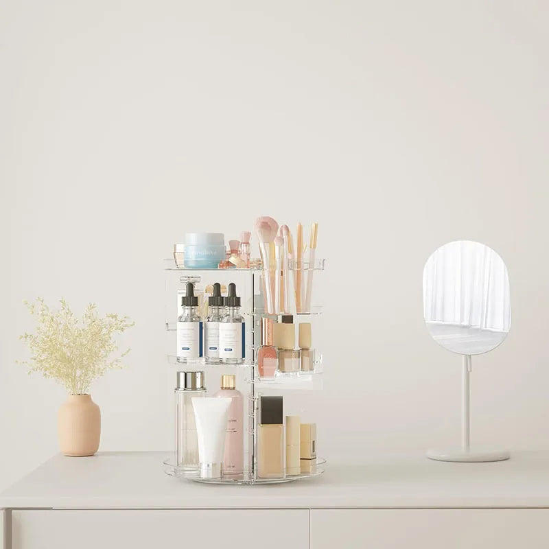 Cosmetic organizer with skincare products on a white surface, with a neutral background. 31 cm makeup carousel, adjustable vanity organizer, clear skincare storage rack, brush holder perfume tray.