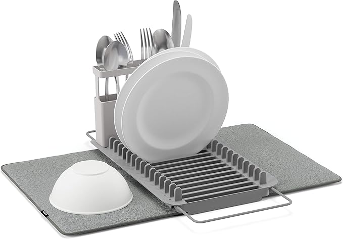 Gray dish rack with plates, bowls, and utensils on a white background