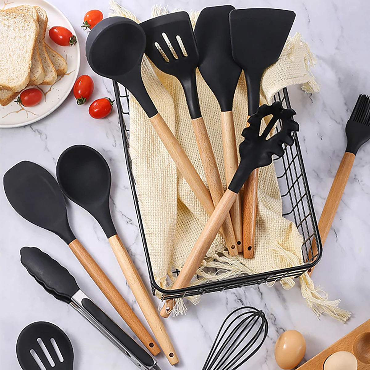 Set of black silicone kitchen utensils with wooden handles on a marble surface. silicone wooden handle kitchen utensil set Pakistan.