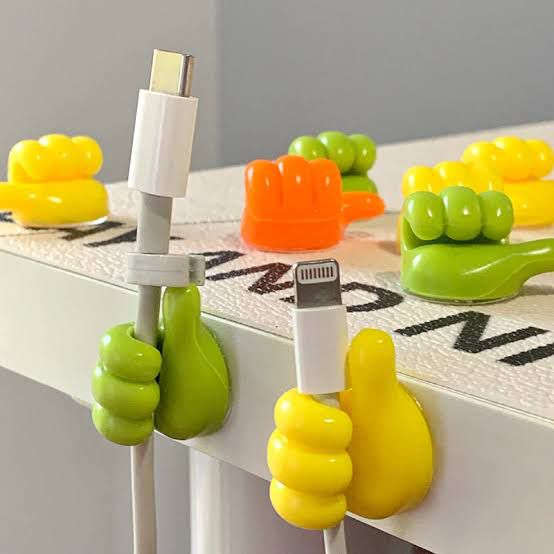 Colorful cable clips on a table with letters on it