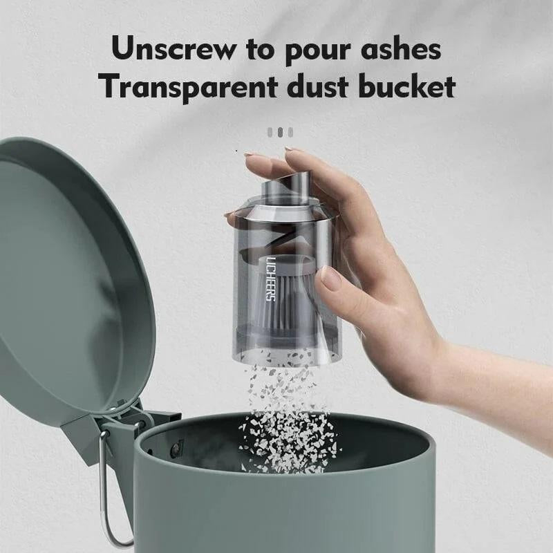 Transparent dust bucket with a hand unscrewing it to pour ashes onto a gray container.