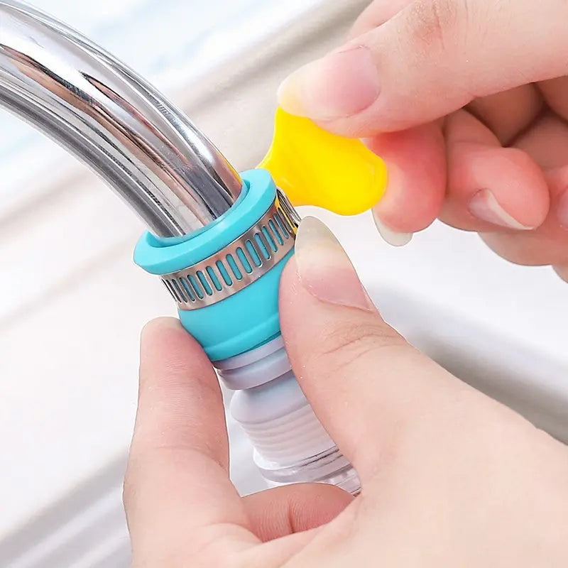 Person holding a blue and silver filter with a yellow hook with a faucet. rotating faucet filter, water saving tap nozzle, kitchen sink aerator pk, 360 splash sprayer, faucet booster Pakistan
