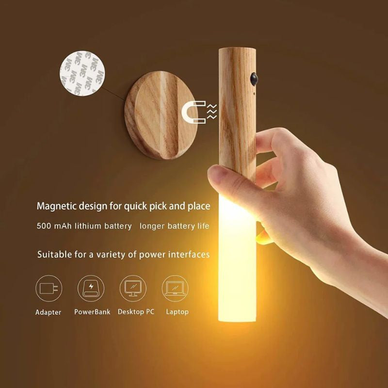 Hand holding a wooden light bulb with magnetic design features on a brown background.  magnetic motion sensor night light, wooden rechargeable night lamp.