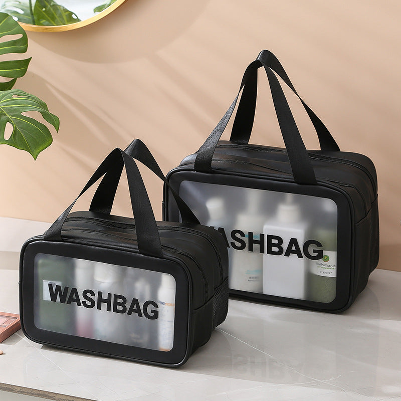 Two black washbags with transparent sides on a beige surface.